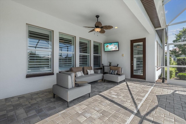 view of patio / terrace featuring outdoor lounge area, ceiling fan, and glass enclosure