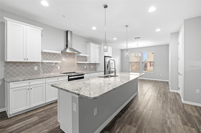 kitchen featuring an island with sink, white cabinetry, stainless steel range with electric stovetop, and sink