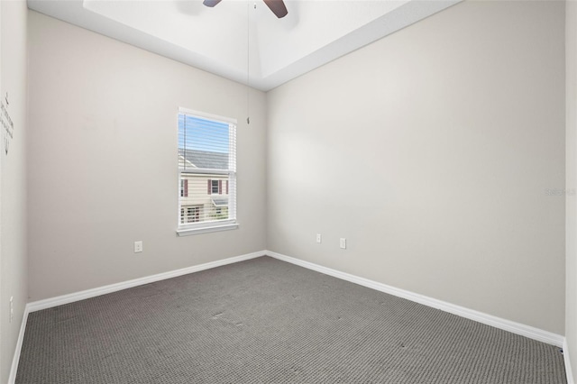 carpeted spare room featuring ceiling fan