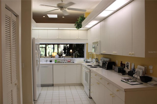 kitchen with ceiling fan, sink, white appliances, white cabinetry, and light tile patterned floors