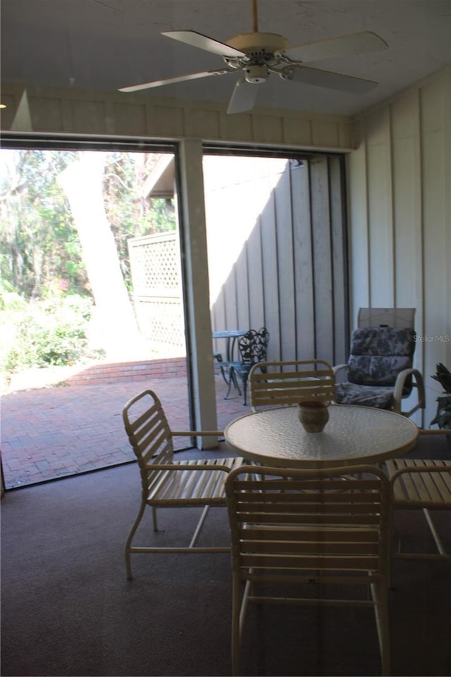 sunroom / solarium featuring ceiling fan