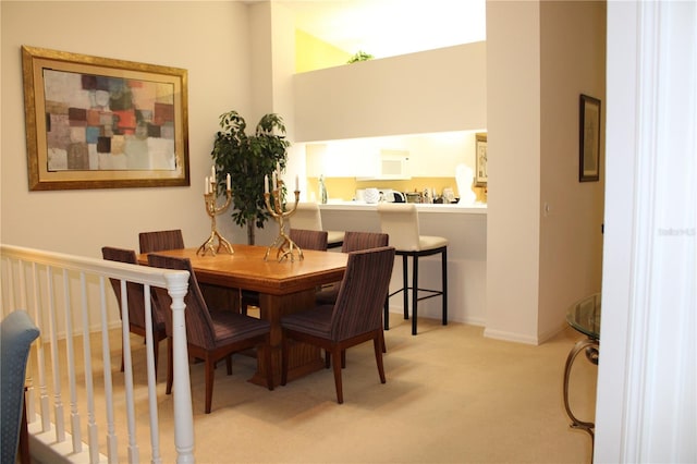 dining area featuring light colored carpet