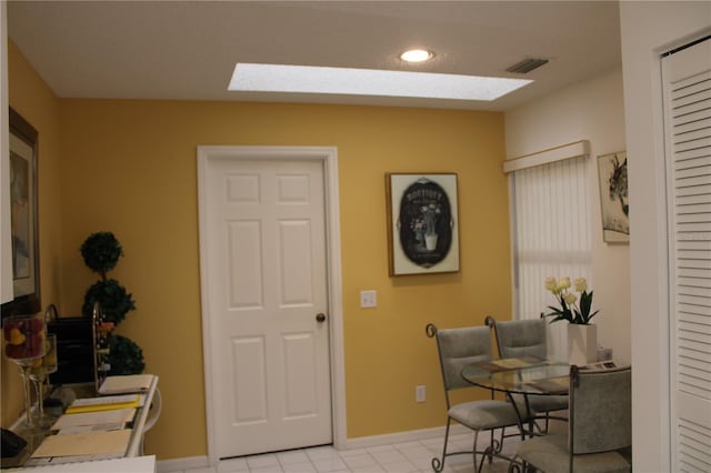 tiled office space with a skylight