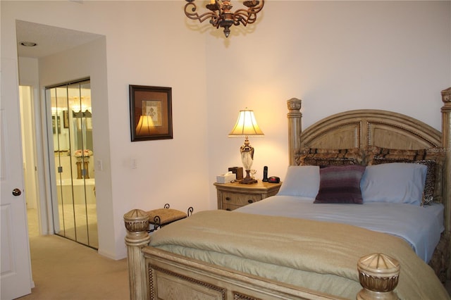 bedroom featuring light carpet and a chandelier