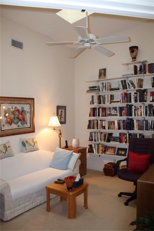 carpeted bedroom featuring ceiling fan and a skylight