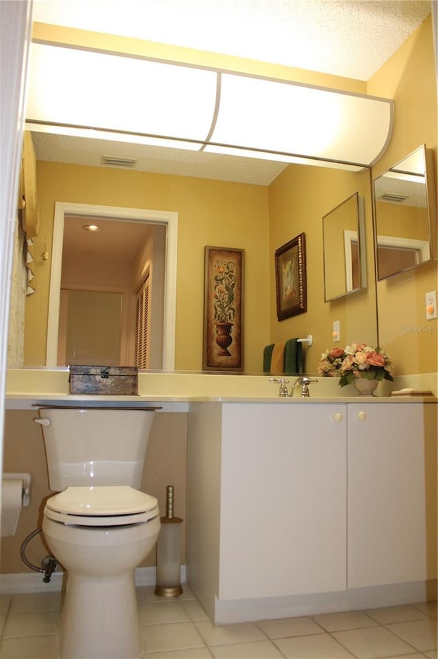 bathroom featuring tile patterned floors, vanity, and toilet