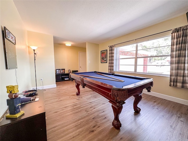 game room featuring pool table, hardwood / wood-style floors, and a textured ceiling