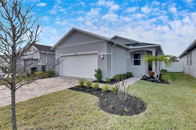 view of front of house with a garage and a front yard