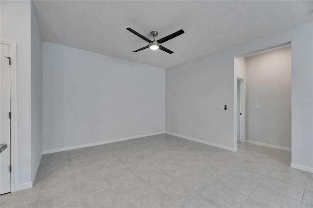 tiled spare room featuring ceiling fan and a textured ceiling