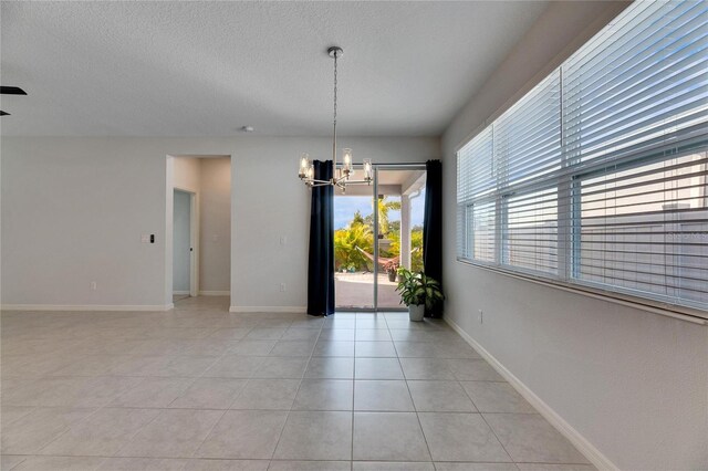 unfurnished dining area with light tile patterned floors and a chandelier