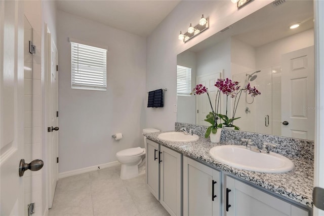 bathroom featuring tile patterned flooring, vanity, toilet, and a shower with shower door