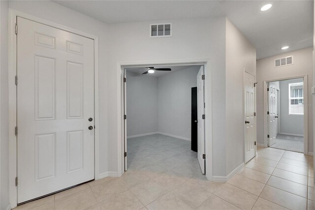 hall featuring light tile patterned floors