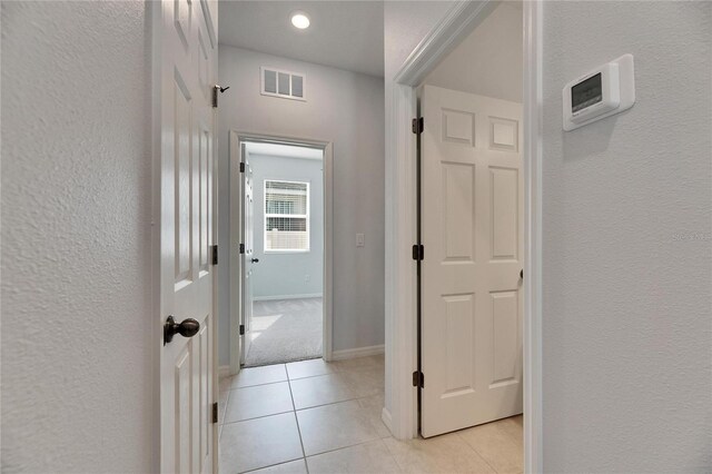 corridor featuring light tile patterned flooring