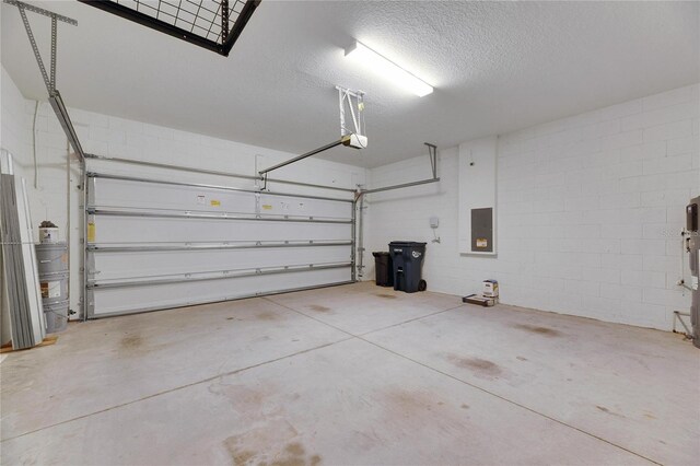 garage featuring electric panel and a garage door opener