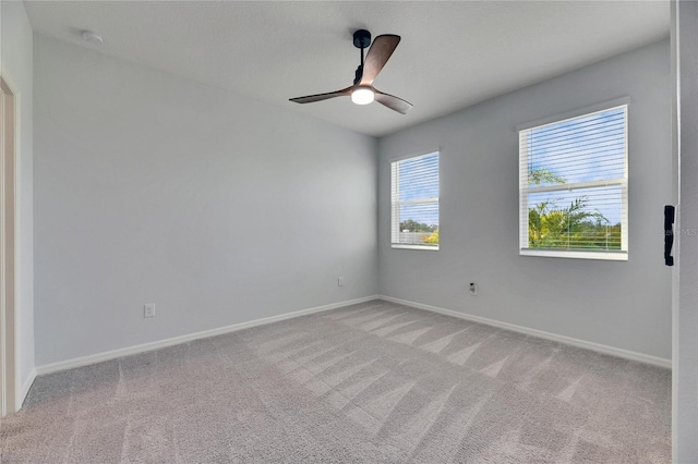 spare room with light carpet and ceiling fan