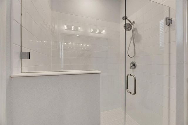 bathroom with a shower with door