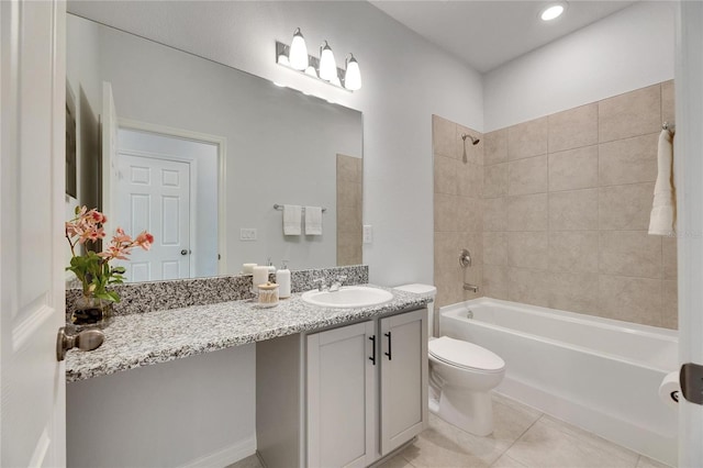 full bathroom with toilet, tile patterned flooring, tiled shower / bath combo, and vanity