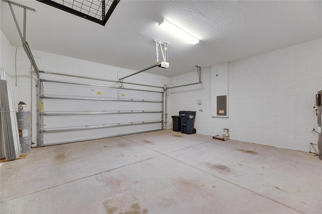 garage with a garage door opener and electric panel