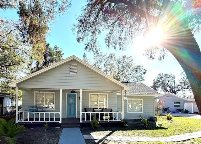 view of front facade with covered porch and a front yard