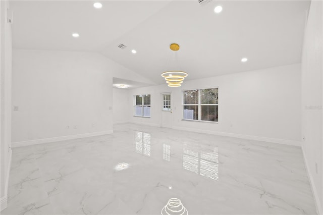 empty room featuring lofted ceiling