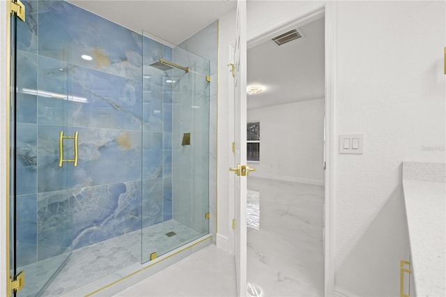 bathroom with a shower with door