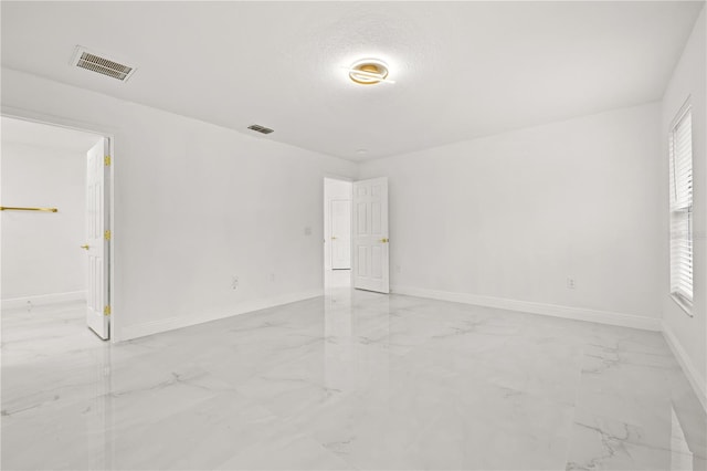 empty room featuring a textured ceiling