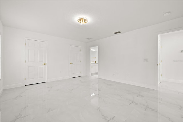 unfurnished room with a textured ceiling