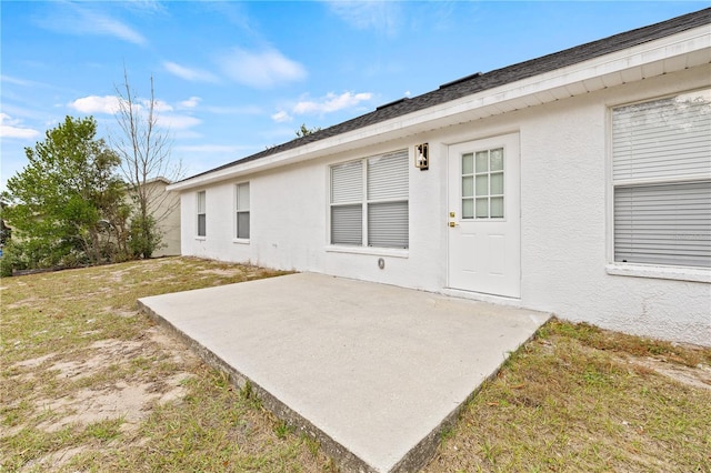 back of house featuring a patio area and a yard