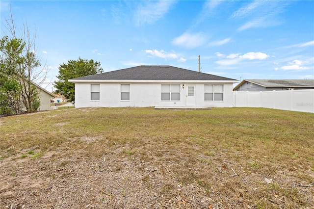 rear view of property with a yard