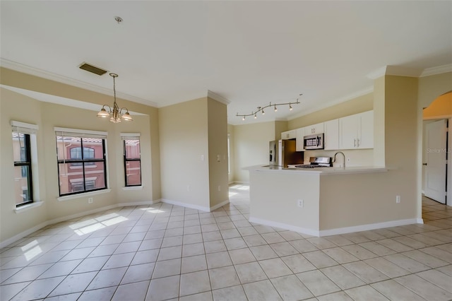 kitchen featuring stainless steel appliances, decorative light fixtures, white cabinetry, ornamental molding, and kitchen peninsula