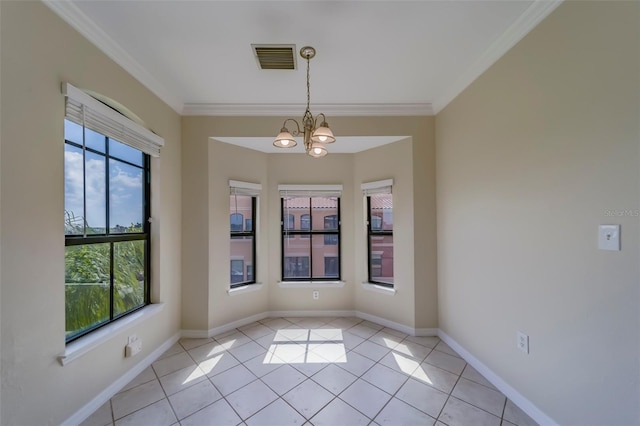 empty room with a notable chandelier, crown molding, and light tile patterned floors