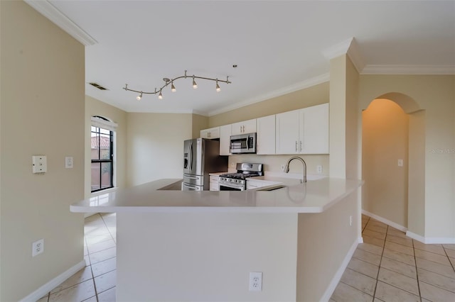 kitchen featuring kitchen peninsula, stainless steel appliances, light tile patterned floors, white cabinets, and sink