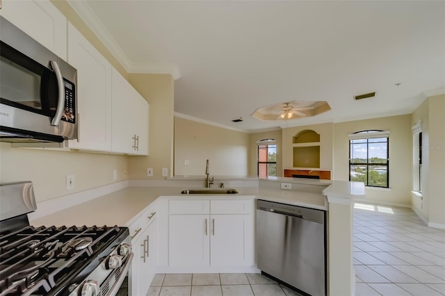 kitchen featuring sink, stainless steel appliances, white cabinets, and kitchen peninsula