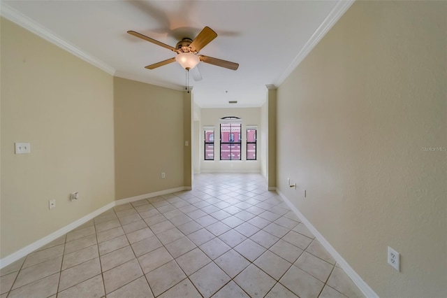 tiled empty room with ceiling fan and ornamental molding