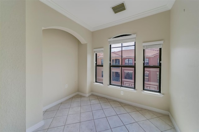 tiled spare room with ornamental molding