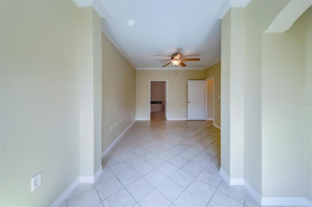 spare room with light tile patterned flooring, ceiling fan, and crown molding