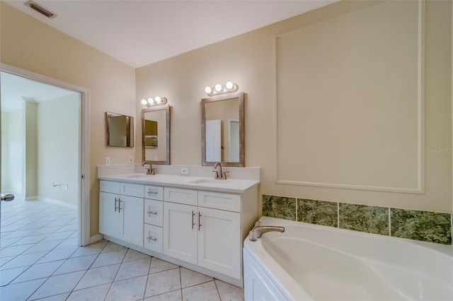 bathroom featuring vanity, a tub, and tile patterned floors