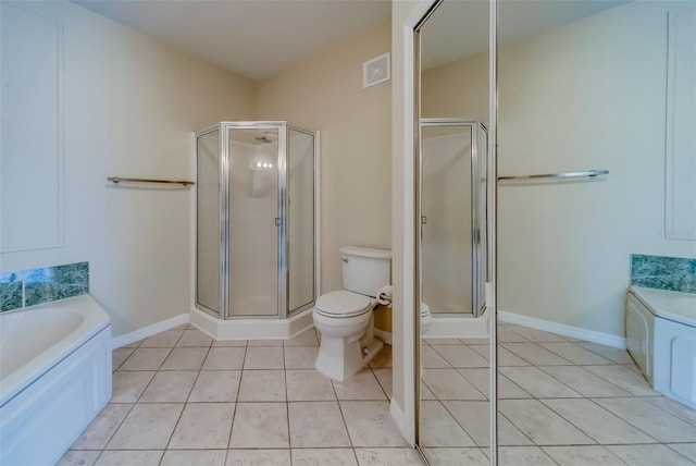 bathroom featuring tile patterned flooring, plus walk in shower, and toilet