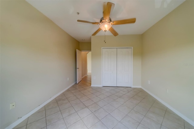 unfurnished bedroom with ceiling fan, a closet, and light tile patterned floors