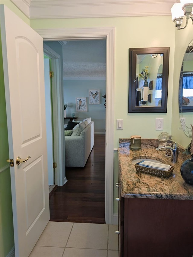 bathroom featuring a chandelier, wood-type flooring, vanity, and ornamental molding