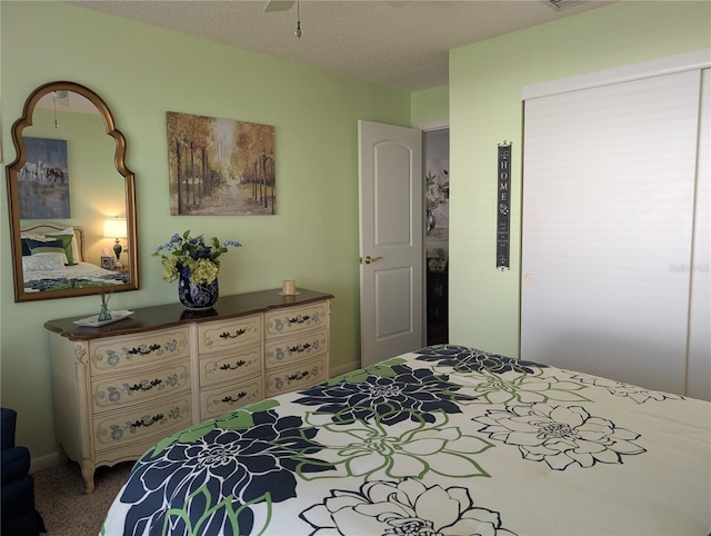 bedroom with carpet floors and a textured ceiling