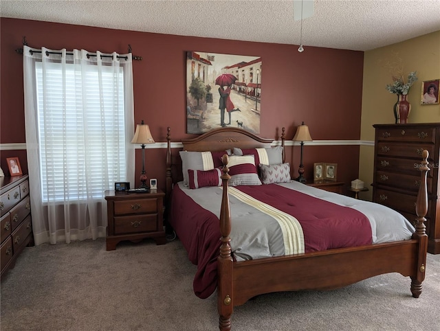 carpeted bedroom featuring a textured ceiling