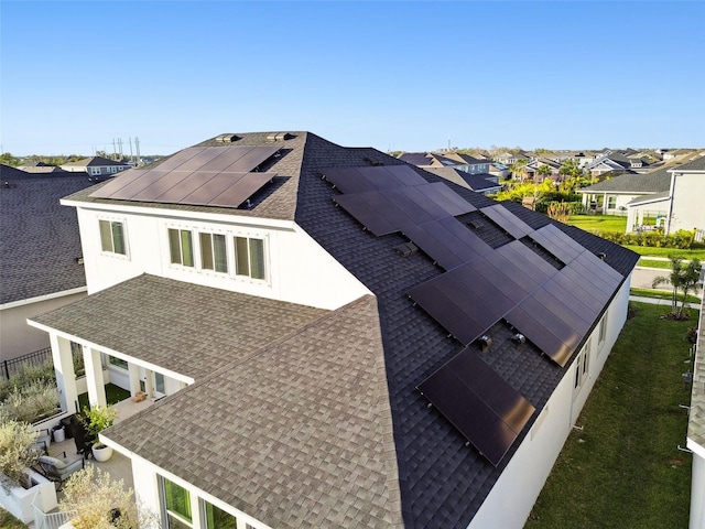 view of side of property featuring solar panels