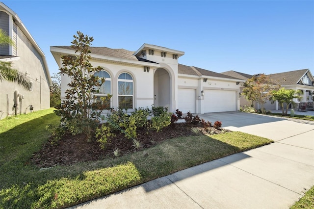 mediterranean / spanish-style house with a garage and a front yard