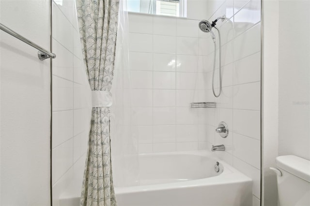 bathroom with shower / tub combo and toilet