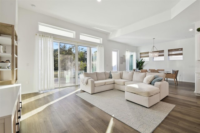 living room featuring an inviting chandelier and wood-type flooring