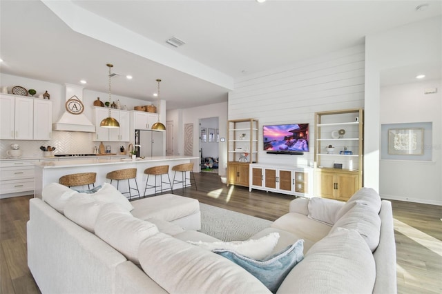 living room with dark hardwood / wood-style floors and sink