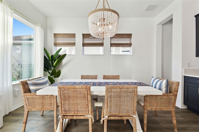 dining area featuring an inviting chandelier and dark hardwood / wood-style floors