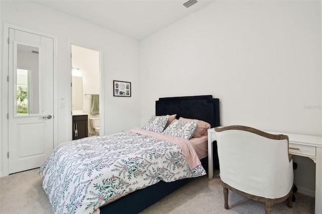 carpeted bedroom with ensuite bathroom