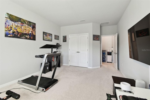 exercise room featuring light colored carpet